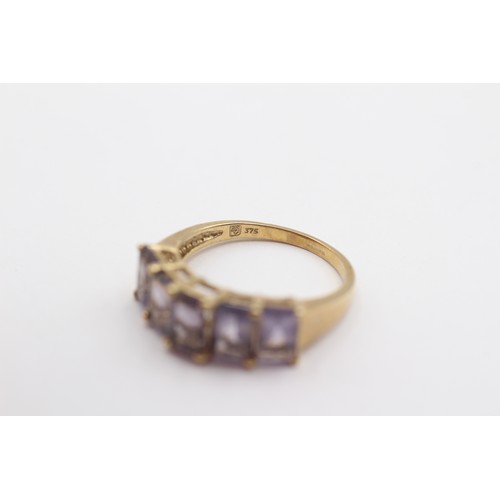 394 - A 9ct gold and purple gemstone set ring, M, 2.5gm