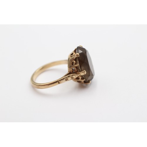 418 - A vintage 9ct gold and oval smokey quartz dress ring, 16 x 12mm, L 1/2, 4gm