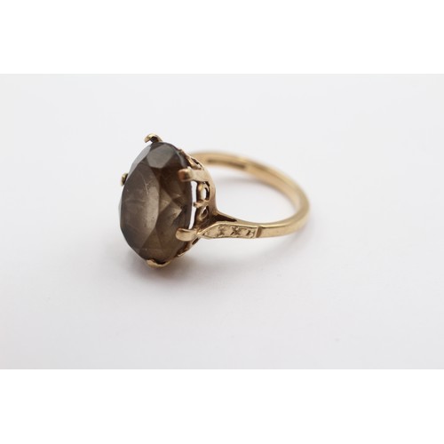 418 - A vintage 9ct gold and oval smokey quartz dress ring, 16 x 12mm, L 1/2, 4gm