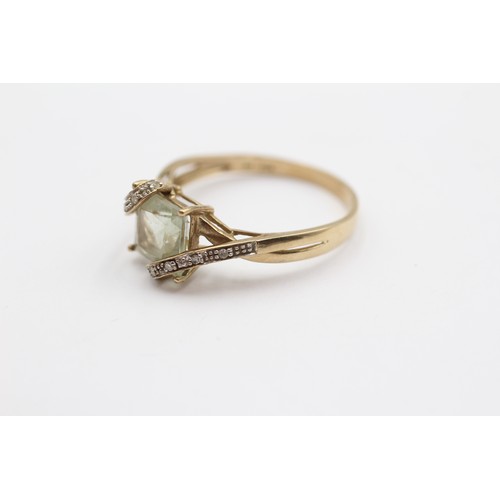 423 - A 9ct gold green quartz and diamond set dress ring, X, 3gm