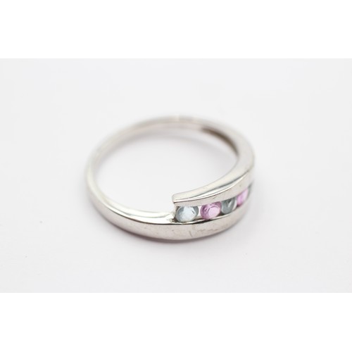 426 - A 9ct white gold pink sapphire and topaz dress ring, T, 3.3gm