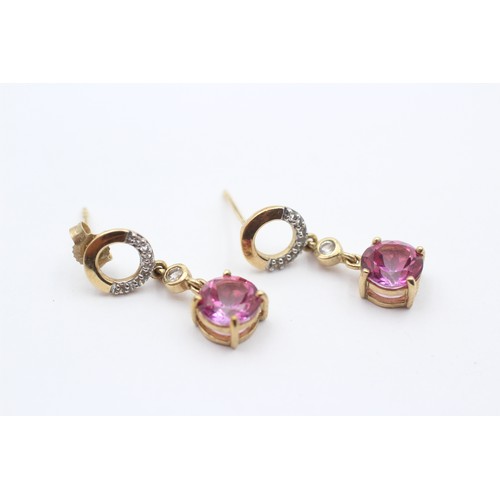 428 - A 9ct gold pair of diamond and pink stone ear rings, 23mm, 2.7gm