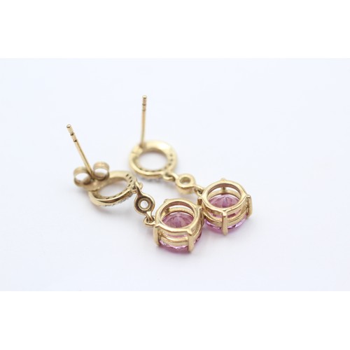 428 - A 9ct gold pair of diamond and pink stone ear rings, 23mm, 2.7gm