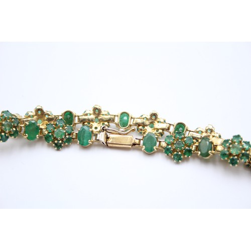 430 - A 14K gold emerald and treated emerald cluster bracelet, 18cm, 12.3gm.