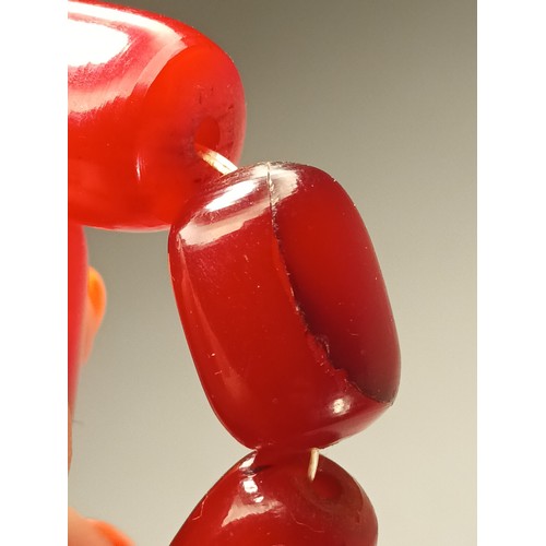 143 - A cherry red amber Bakelite graduated bead necklace, 25 - 12mm beads, 92cm, 96gm