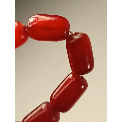 143 - A cherry red amber Bakelite graduated bead necklace, 25 - 12mm beads, 92cm, 96gm