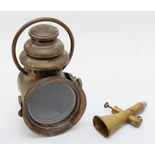 117 - A Kohler & Son brass signal horn, 15cm long, together with a brass oil lamp 'Nirona' No 10 (2)