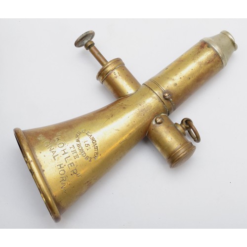 117 - A Kohler & Son brass signal horn, 15cm long, together with a brass oil lamp 'Nirona' No 10 (2)