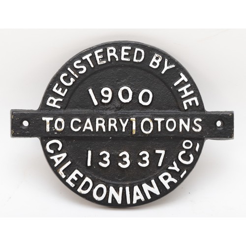 130 - A round cast iron wagon plate 'Caledonian RY.Co. 1900, to carry 10 tons, No 13337'.