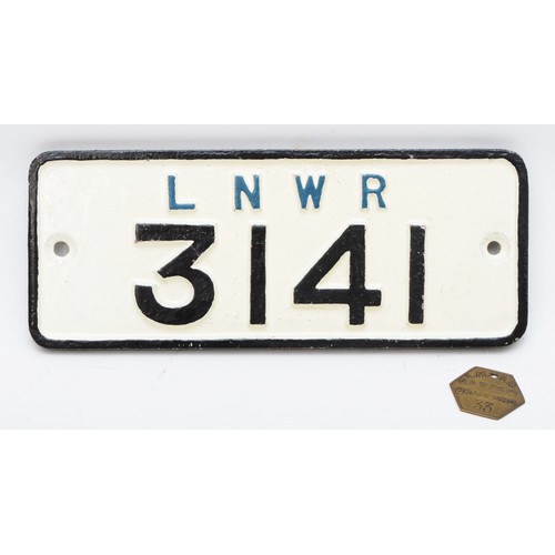 135 - 'L.N.W.R 3141' cast-iron wagon plate together with an L.M.S.R Bradford pay-check. (2)