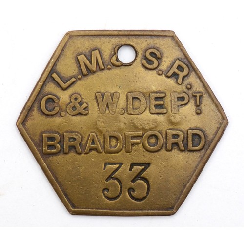 135 - 'L.N.W.R 3141' cast-iron wagon plate together with an L.M.S.R Bradford pay-check. (2)