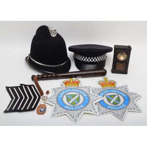 509 - A collection of Lincolnshire Police related items to include a helmet, cap, truncheon, an early lamp... 