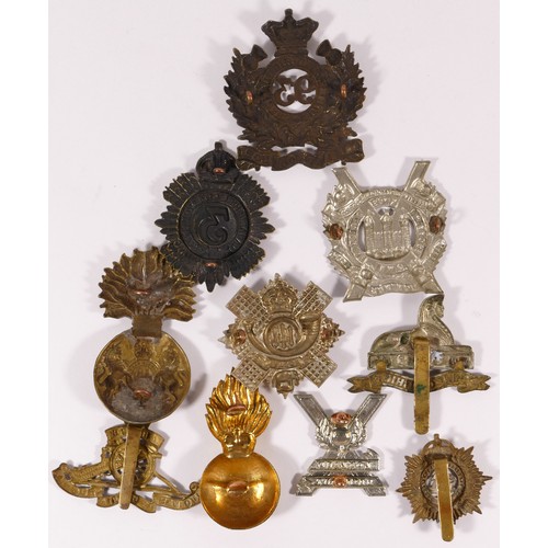 513 - Ten military cap badges, including Highland Light Infantry