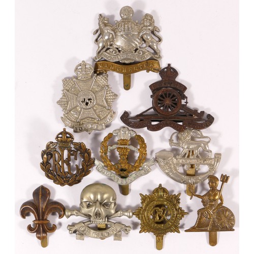 517 - Ten military cap badges, including Royal Flying Corps and Manchester Regt