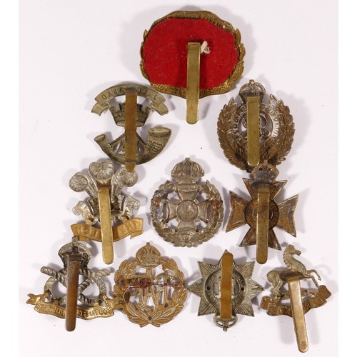 519 - Ten military cap badges, including South Lancs and South Staffs