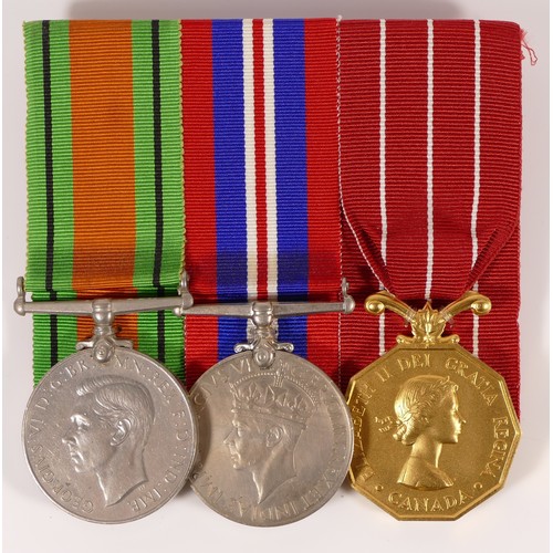 545 - WWII mounted group of three, including named Canadian Service Medal, named Captain M.R. Prentis