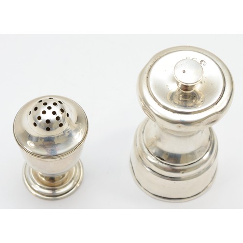 22 - A George V silver mechanical pepper pot, Birmingham 1920, together with another pepper pot, Birmingh... 