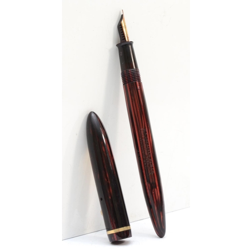 77 - Sheaffer's, a red and black fountain pen, 13.5cm.