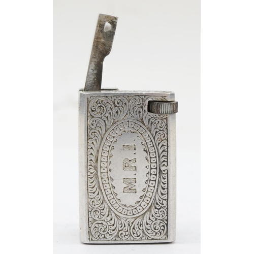 89 - A rectangular metal petrol lighter with chased floral and scroll decoration, 4 x 2 x 2.5cm.