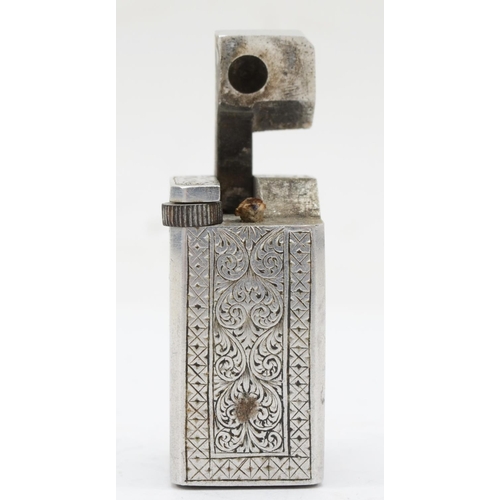 89 - A rectangular metal petrol lighter with chased floral and scroll decoration, 4 x 2 x 2.5cm.