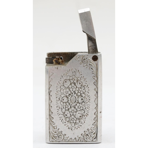 89 - A rectangular metal petrol lighter with chased floral and scroll decoration, 4 x 2 x 2.5cm.