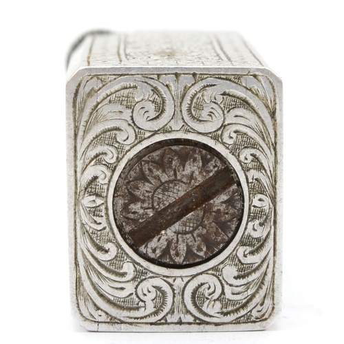 89 - A rectangular metal petrol lighter with chased floral and scroll decoration, 4 x 2 x 2.5cm.