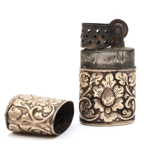 90 - A silver cased petrol lighter, unmarked, with embossed floral decoration, 6 x 3.5 x 2cm.