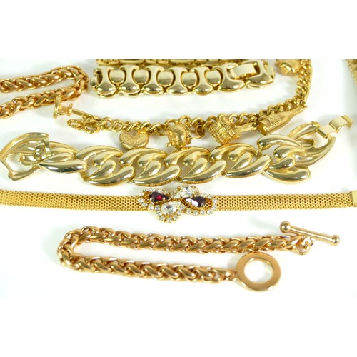 142 - A group of gold plated bracelets to include a bangles, a charm braclet, 631gm