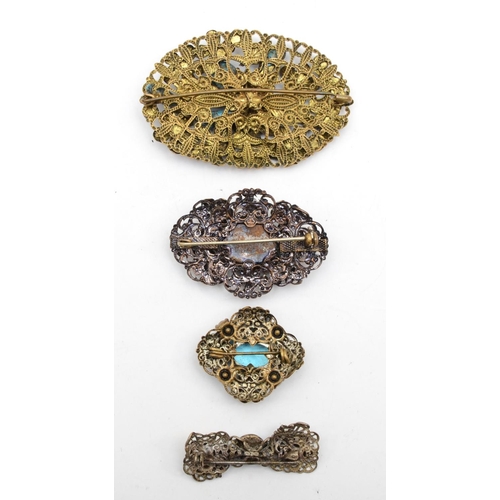 152 - Four Czech filigree metal brooches to include turquoise glass examples.