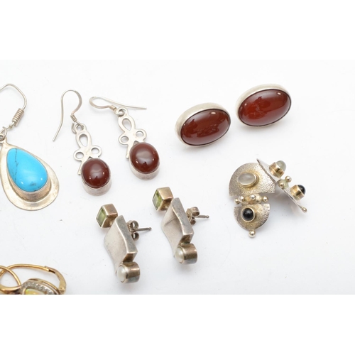 180 - A group of silver earrings to include carnelian and peridot examples, 58gm.