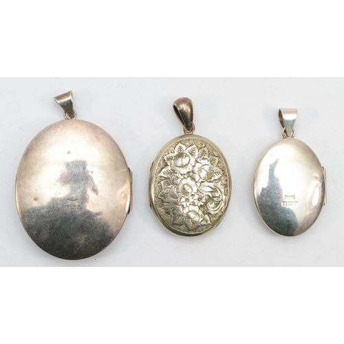 191 - Two silver lockets with chase floral and scrolling detail, largest 5.5cm, 33gm, together with a Vict... 