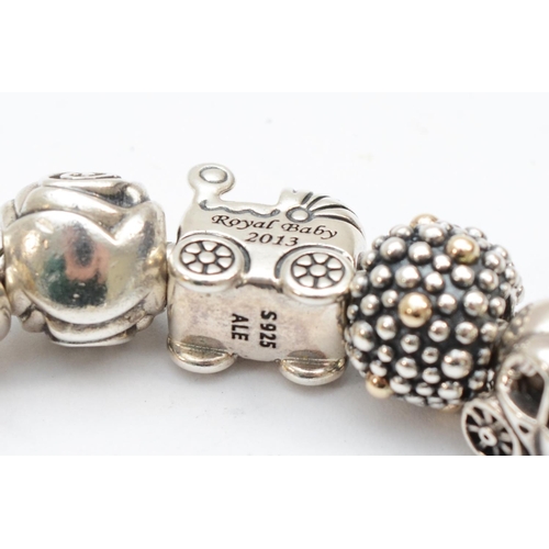 199 - Pandora, a boxed silver bracelet with fourteen charms, 69gm.