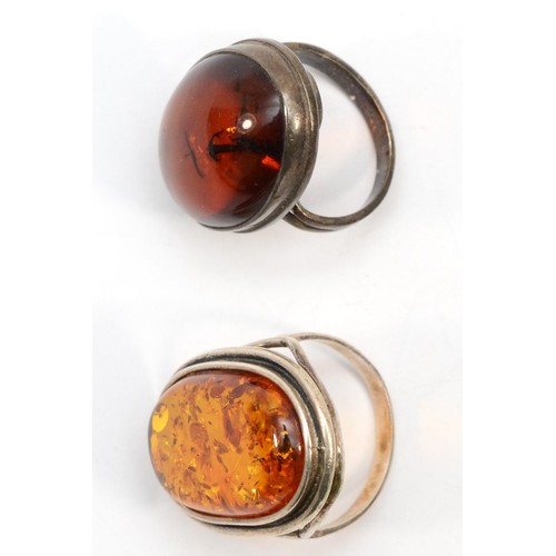 212 - Two silver Baltic amber rings, size Q, and L, 14gm.