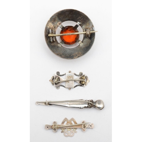 222 - Three Scottish hardstone brooches and a silver twin heart brooch, Chester 1908, 23gm,