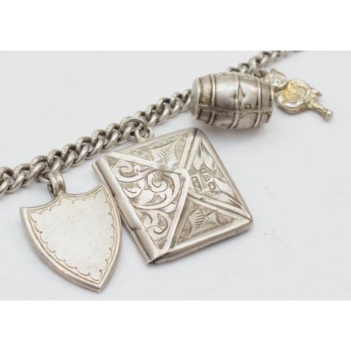 251 - A silver charm bracelet, 17cm, with stamp case Chester 1909, 29gm.