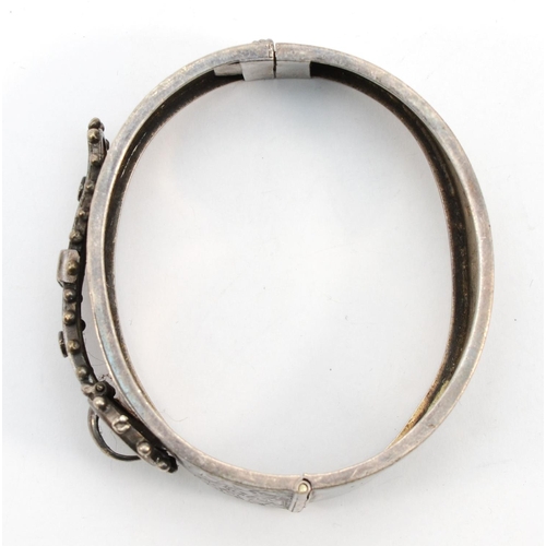 260 - A Victorian silver cuff bangle with buckle and leaf decoration, Birmingham 1882, inside diameter 5.5... 