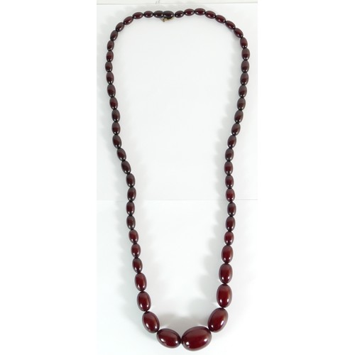 302 - A cherry red amber Bakelite graduated bead necklace, 30 - 11mm beads, 82cm, 63gm