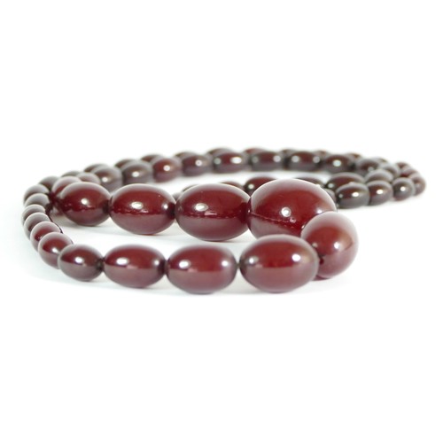 302 - A cherry red amber Bakelite graduated bead necklace, 30 - 11mm beads, 82cm, 63gm