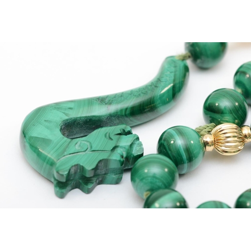 326 - A vintage carved malachite dragon and 9mm bead necklace, 92cm, 156gm.