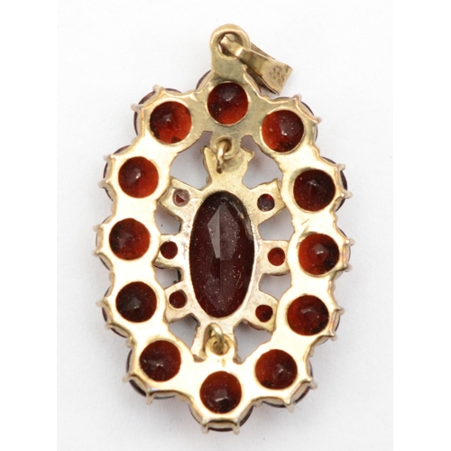 329 - A German 333 stamped gold and Bohemian garnet cluster pendant, 3 x 2 cm, 3.7gm.