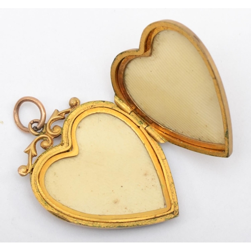 334 - A Victorian 9ct gold front and backed heart shaped locket with seed pearls, 3 x 2 cm.