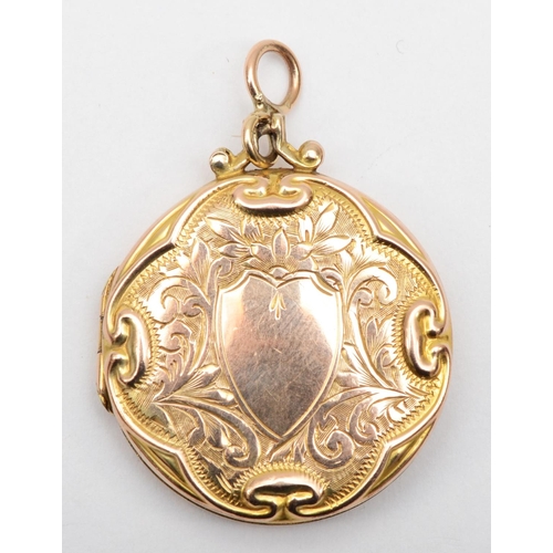 375 - A Victorian 9ct front and back gold locket with scrolling decoration, 3cm.