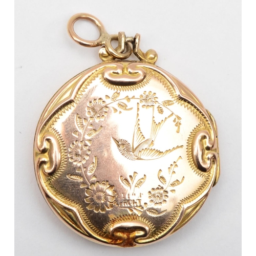 375 - A Victorian 9ct front and back gold locket with scrolling decoration, 3cm.