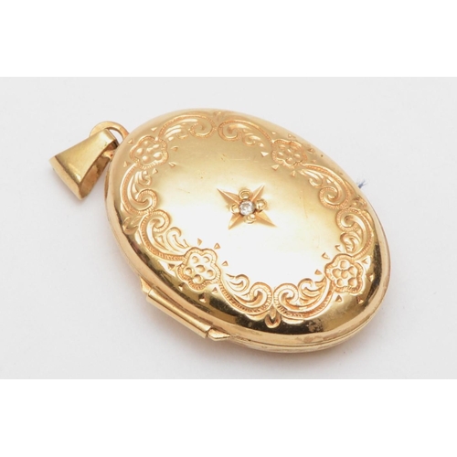 377 - A 9ct gold oval locket with embossed scrolling detail centered with a small diamond, 3 x 2 cm, 3.3gm