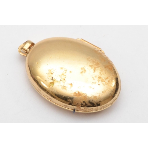 377 - A 9ct gold oval locket with embossed scrolling detail centered with a small diamond, 3 x 2 cm, 3.3gm