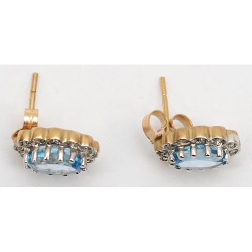 378 - A 375 gold pair of topaz and illusion set diamond cluster earstuds, 1 cm, 1.8gm.