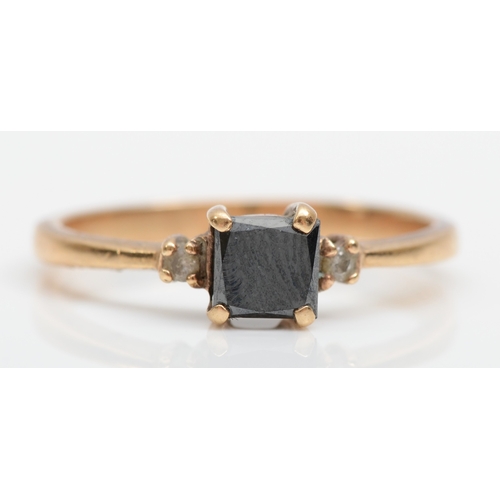 516 - A 9ct gold black stone and diamond ring, Q, 2.2gm