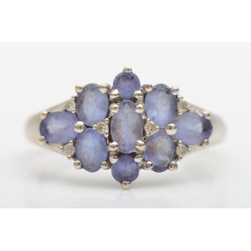 517 - A 9ct white gold, tanzanite and diamond dress ring, L 1/2, 2.8gm