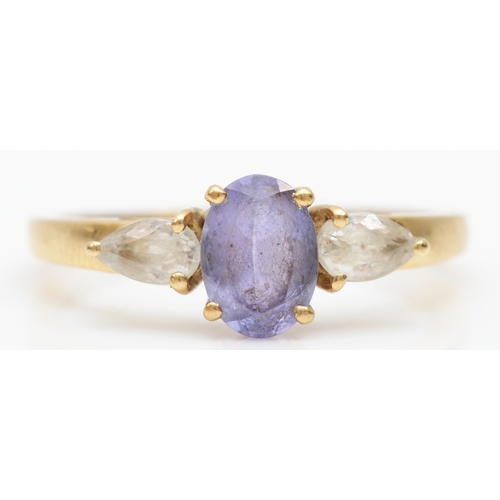 520 - A 9ct gold tanzanite and white gemstone three stone ring, N 1/2, 1.8gm