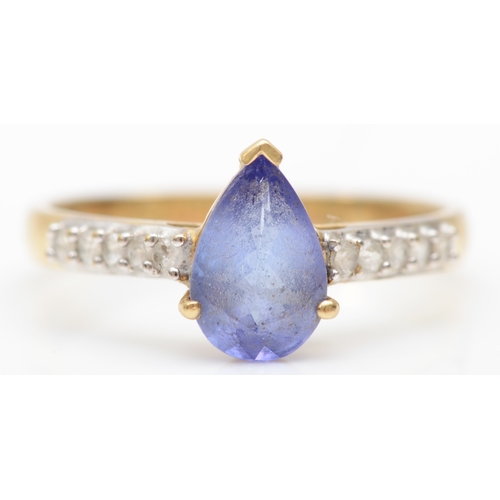 523 - A 9ct gold tanzanite and white gemstone ring, P 1/2, 2.3gm